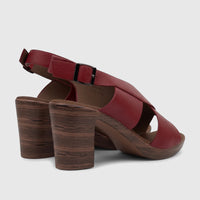 A pair of burnished dark red Hush Puppies Soft Style Ladies Block Heel Sandals, showing the side view with wood-grain heels.