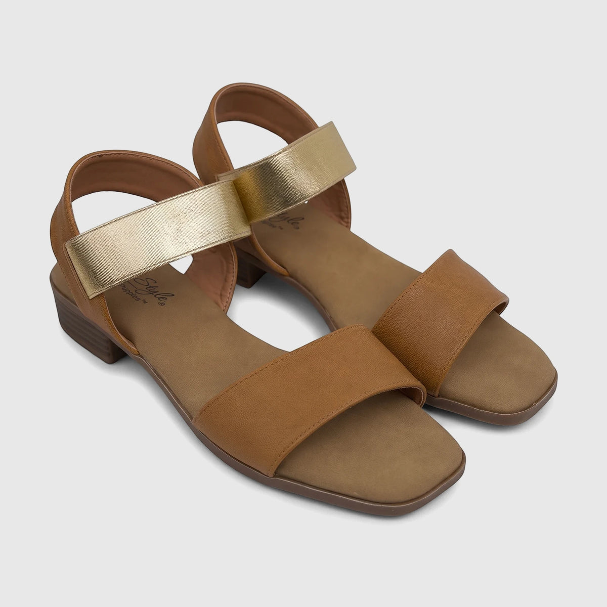 A pair of Hush Puppies Soft Style Harlan tan and gold ladies comfort sandals, featuring an elasticized gold strap.