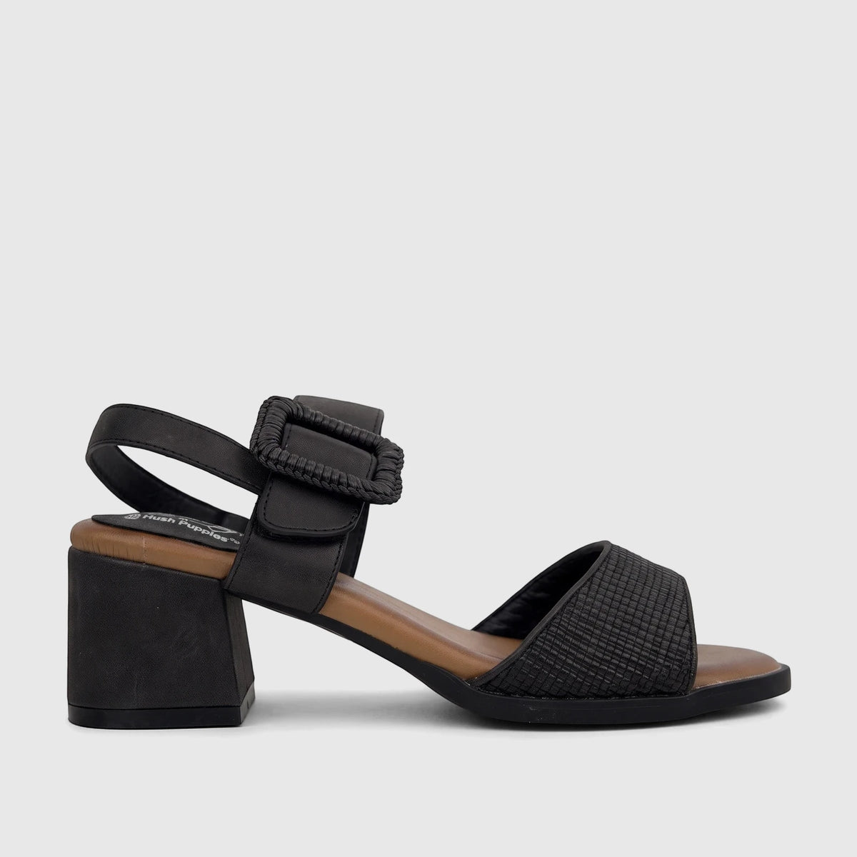 Black Hush Puppies Soft Style Hetty comfort block heel sandal with woven strap and adjustable buckle, side view.