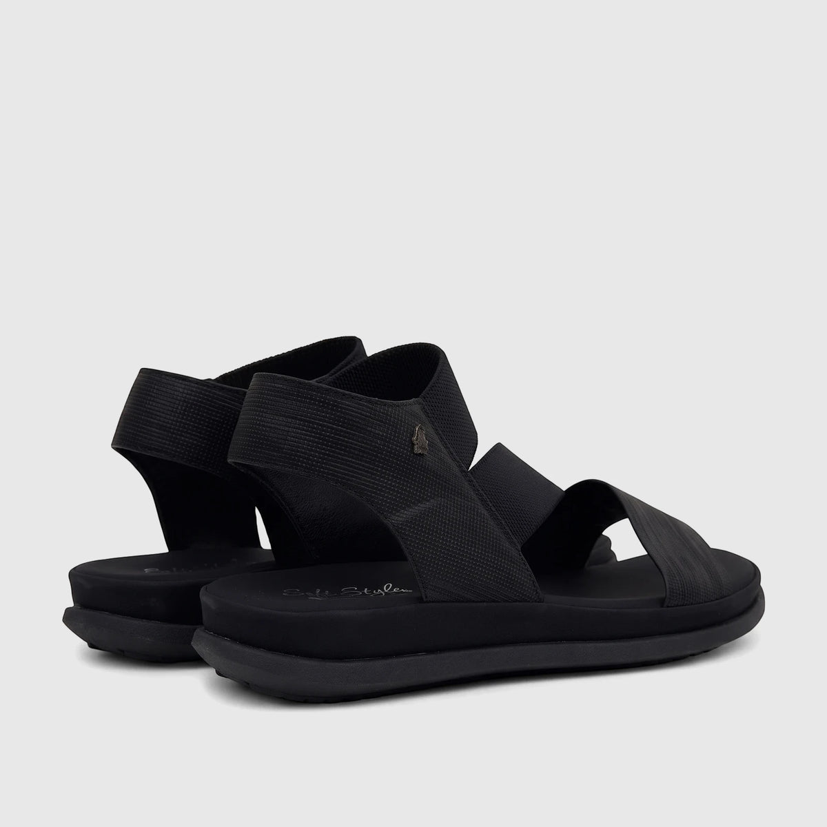 A pair of black Hush Puppies Soft Style Indy comfort sandals with elastic multi-strap design and a platform sole.