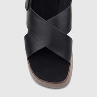 Black Hush Puppies Soft Style Jemma comfort wedge sandals with criss-cross straps and a wooden-look sole, front view.