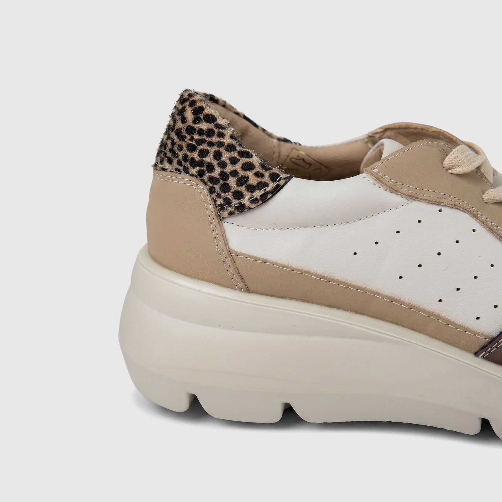 Hush Puppies Soft Style Jolanda ladies comfort sneaker in beige and white with leopard print heel, side view.