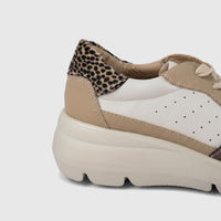 Hush Puppies Soft Style Jolanda ladies comfort sneaker in beige and white with leopard print heel, side view.