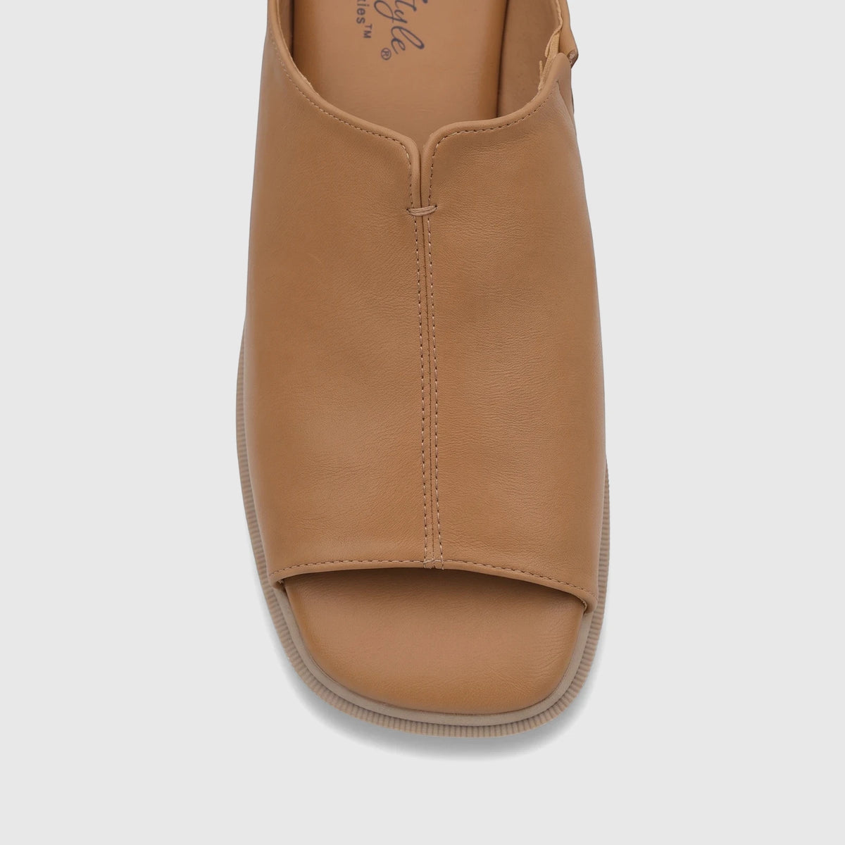 Close-up of a tan Hush Puppies Soft Style Kathan comfort sandal, featuring an open-toe design and smooth caramel-colored