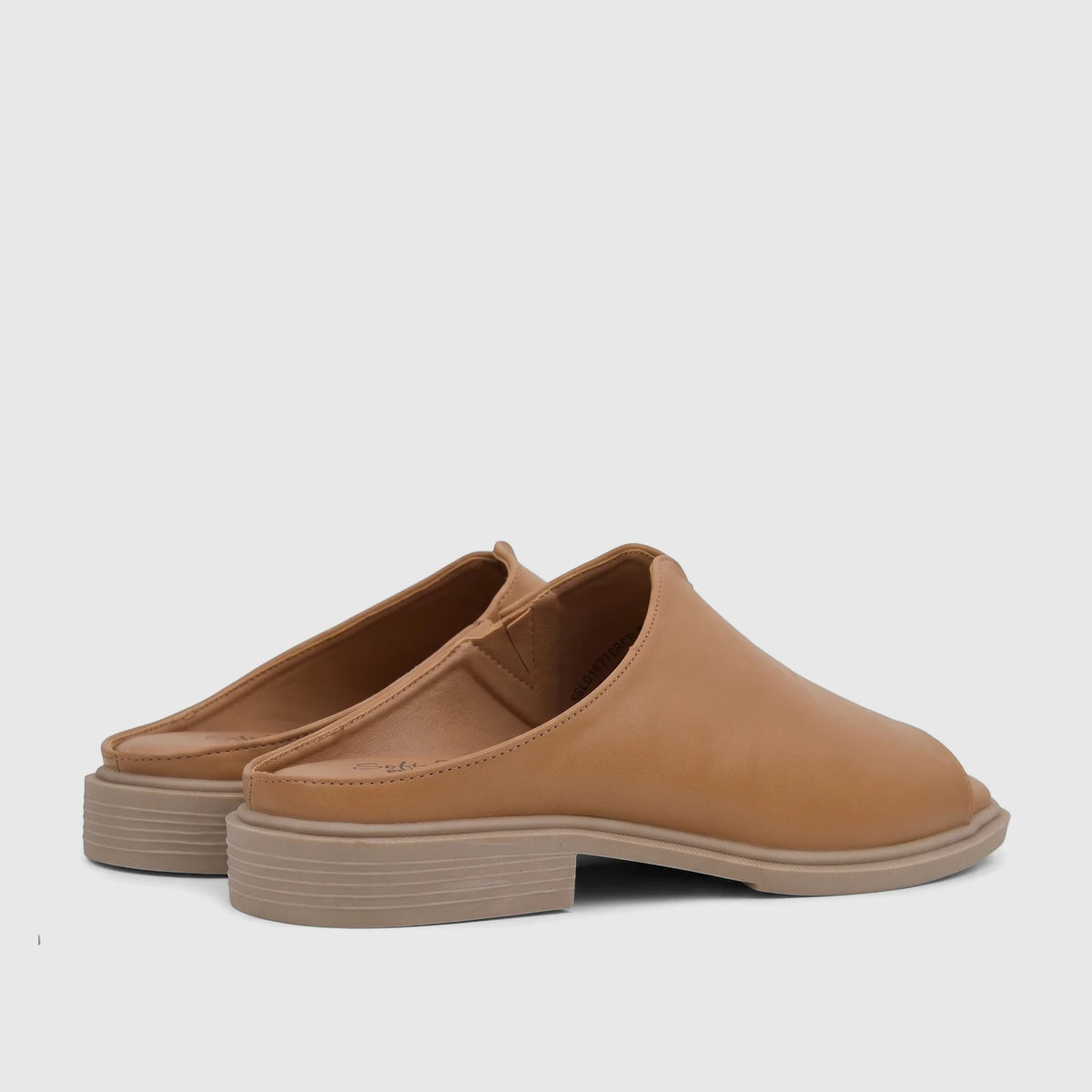 Pair of Hush Puppies Soft Style Kathan comfort sandals in caramel, featuring an open-toe design and a ridged platform sole,
