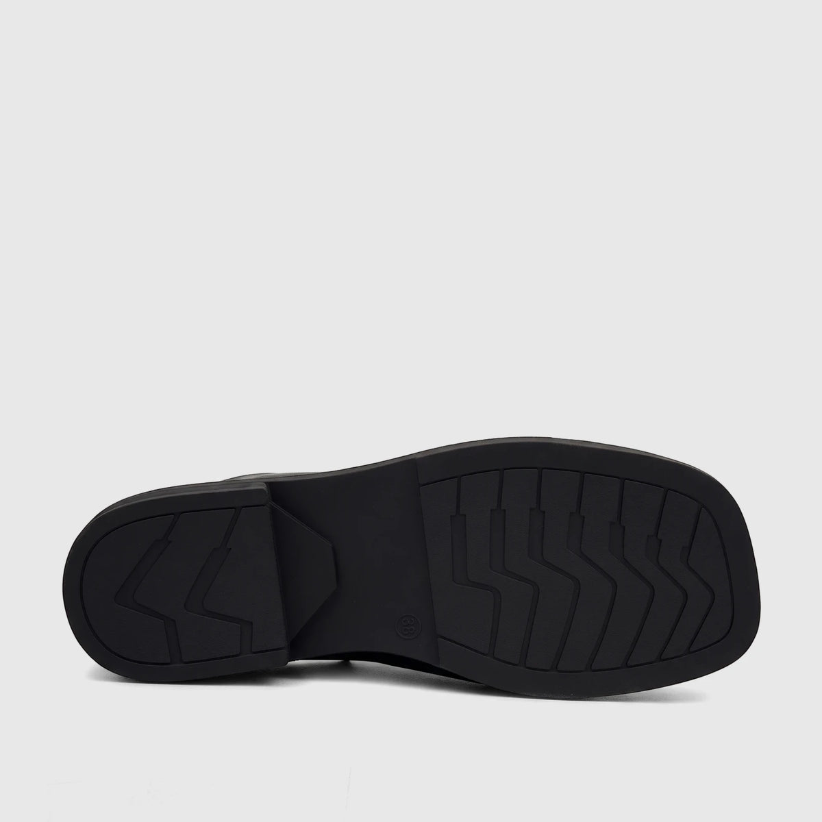 Bottom view of a Hush Puppies Soft Style ladies' black comfort sandal, showcasing the durable sole with intricate tread