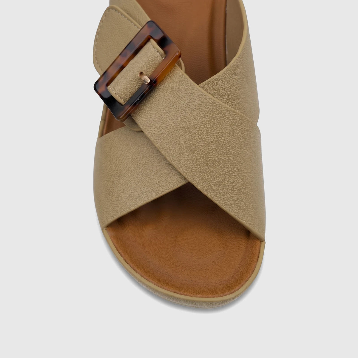 Close-up of a Hush Puppies Soft Style Ladies Block Heel Sandal in fawn, featuring crossed beige straps and a tortoise-shell