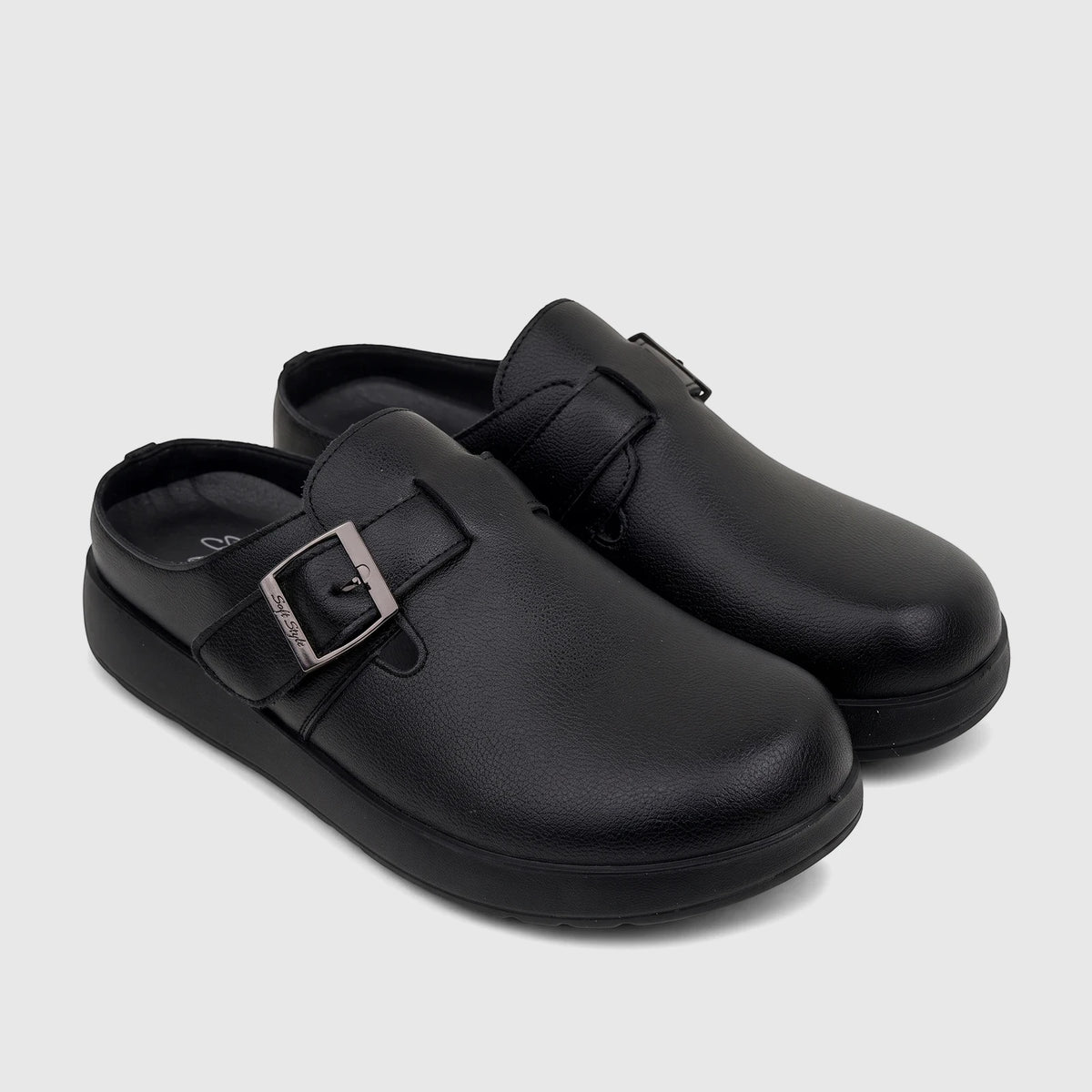 Pair of black leather Hush Puppies Soft Style ladies comfort clogs, featuring a silver buckle detail, on a white background.