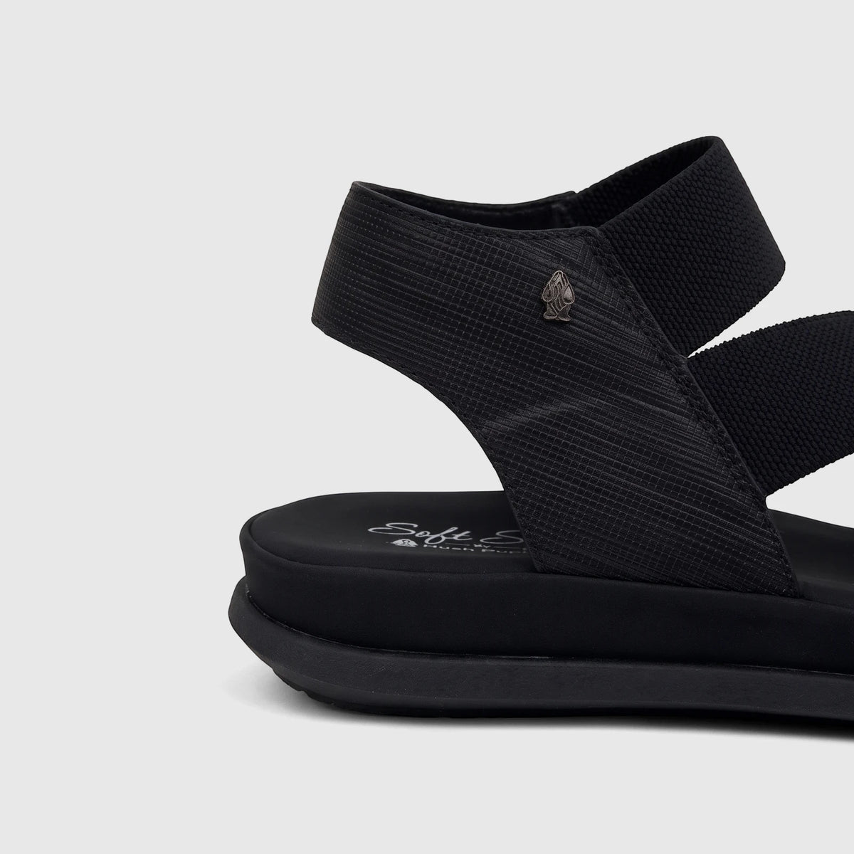Hush Puppies Soft Style Ladies Comfort Sandal Indy in black, featuring textured straps and a chunky sole, shown from a side
