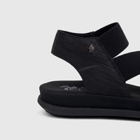 Hush Puppies Soft Style Ladies Comfort Sandal Indy in black, featuring textured straps and a chunky sole, shown from a side