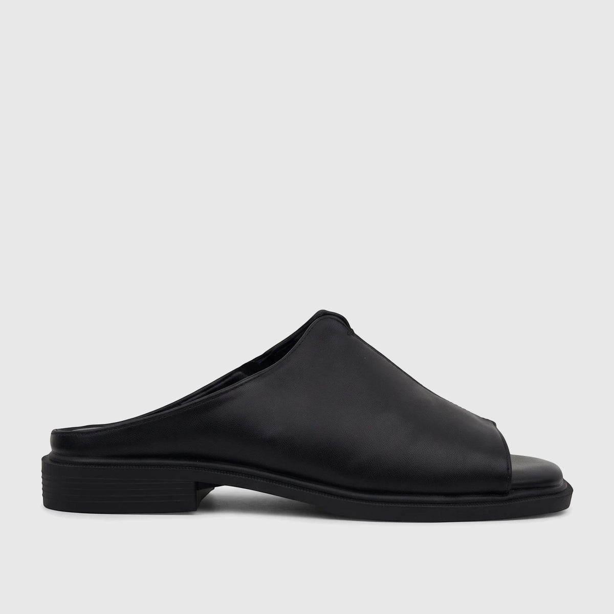 Black Hush Puppies Soft Style Ladies Comfort Sandal Kathan SSL01677, a sleek open-toe mule with a low block heel, shown in a