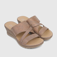 A pair of Hush Puppies Soft Style Posha comfort sandals for ladies, featuring bronze-textured criss-cross straps and a beige