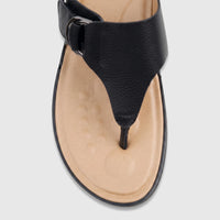 Close-up view of a single Hush Puppies Soft Style Ladies Comfort Sandal Tanya in black, featuring a textured upper and light
