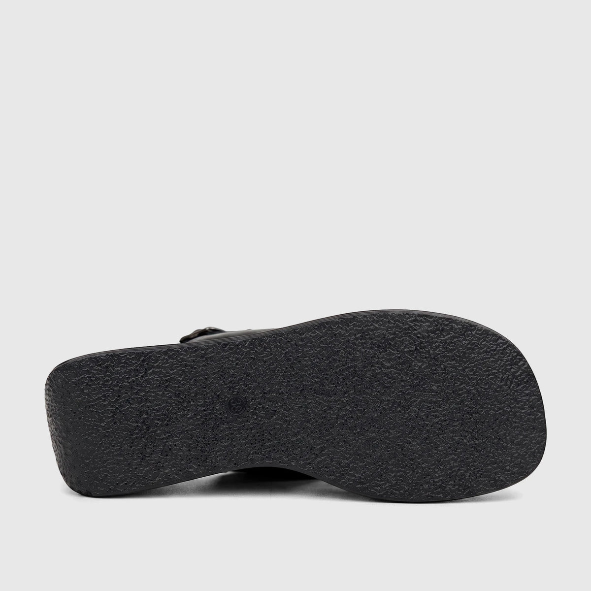 Bottom view of a black Hush Puppies Soft Style ladies' comfort wedge shoe, showcasing the textured sole and sturdy design.