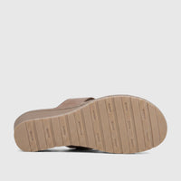 Bronze Hush Puppies Soft Style Ladies Comfort Wedge Sandal, shown from the underside to highlight the patterned sole.