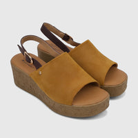 Yellow Hush Puppies Soft Style Ladies Comfort Wedge Sandal. Features brown straps, gold buckle, and cork wedge.