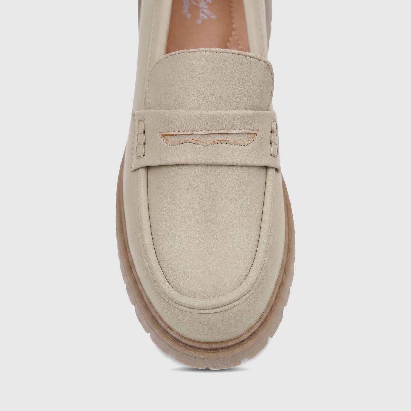 Light sage Hush Puppies Soft Style Lizbeth ladies loafer shoe in a head-on close-up view, showcasing the detailed strap and
