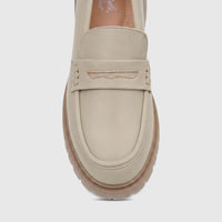 Light sage Hush Puppies Soft Style Lizbeth ladies loafer shoe in a head-on close-up view, showcasing the detailed strap and
