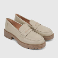 Pair of Hush Puppies Soft Style Lizbeth ladies loafers in light sage, featuring a classic penny loafer design and chunky