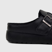 Black Hush Puppies Soft Style Noelle women's comfort clog with a silver buckle detail and platform sole, side view.