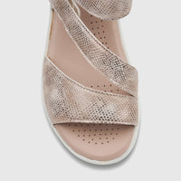 Close-up of a Hush Puppies Soft Style Ladies Comfort Sandal in Ogillian Light Gold with a snakeskin texture and a