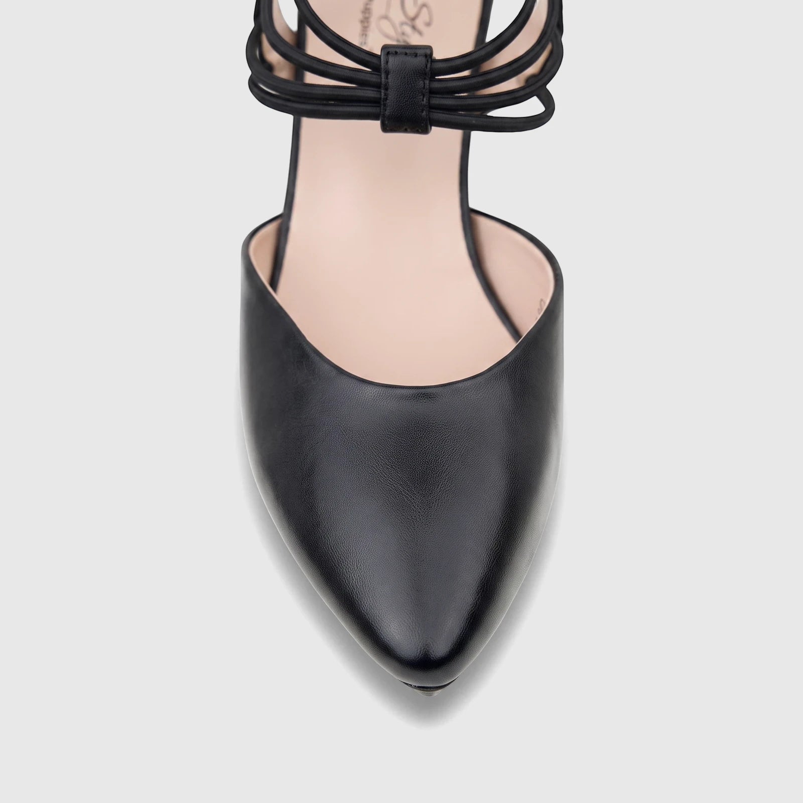 Close-up of a black leather Hush Puppies Soft Style Pharell ladies court shoe with slender ankle straps.