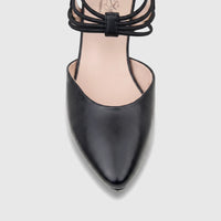 Close-up of a black leather Hush Puppies Soft Style Pharell ladies court shoe with slender ankle straps.