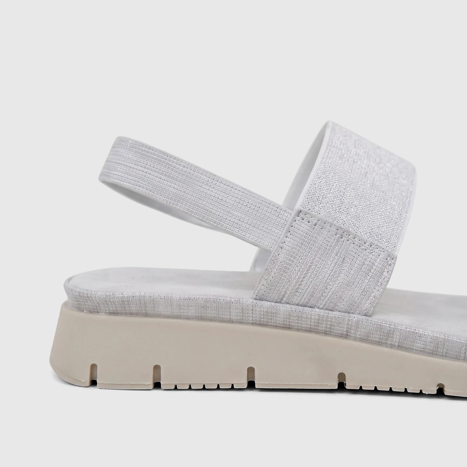 A close-up side view of a Hush Puppies Soft Style Telina ladies comfort sandal in silver with elasticated straps and a beige