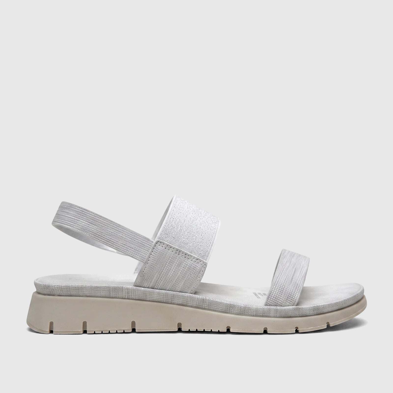 Hush Puppies Soft Style Telina ladies comfort sandal in silver, featuring elastic straps and a chunky sole, shown in a