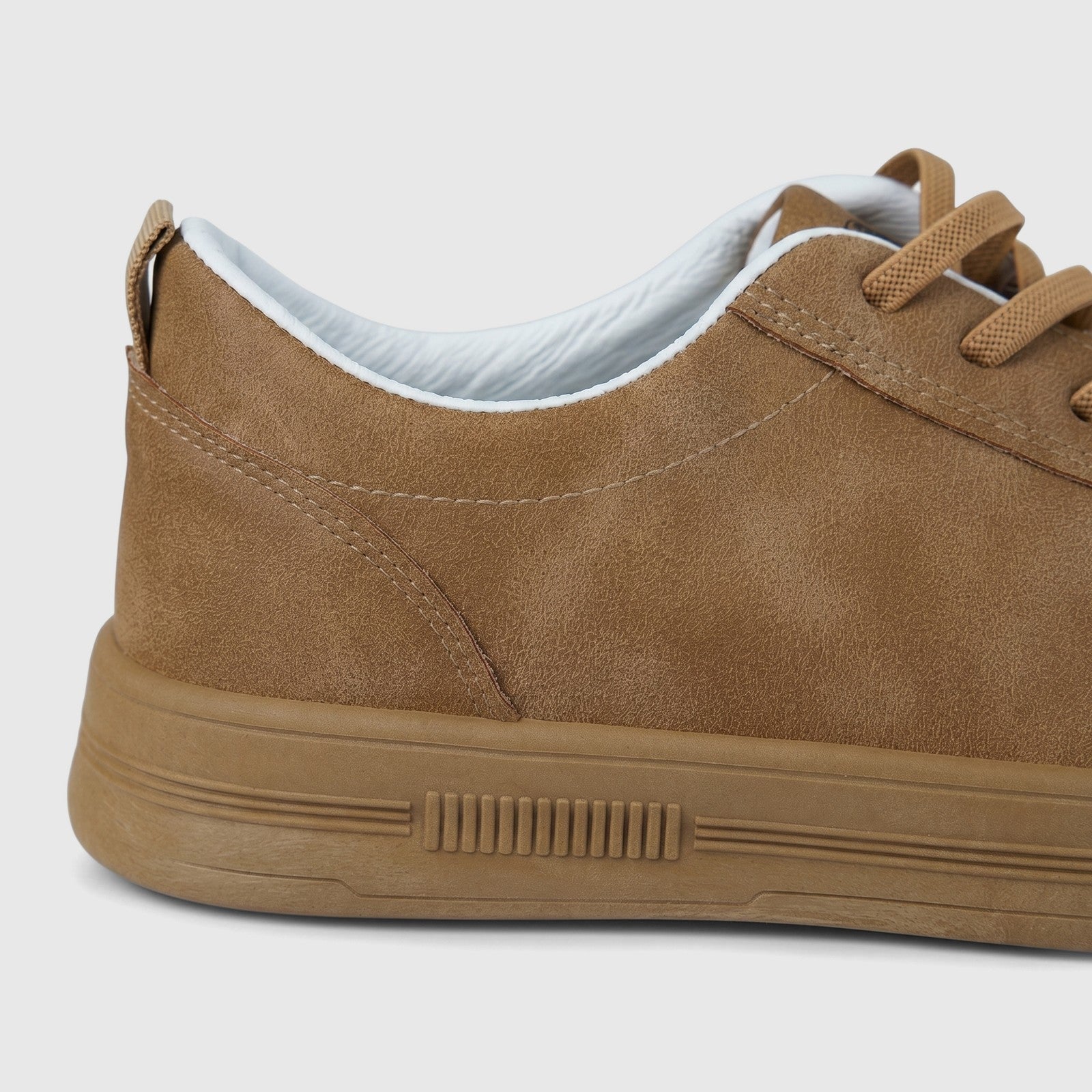 Hush Puppies Soft Style Tavaria ladies comfort sneaker in taupe, side view showing lace-up upper and rubber sole.