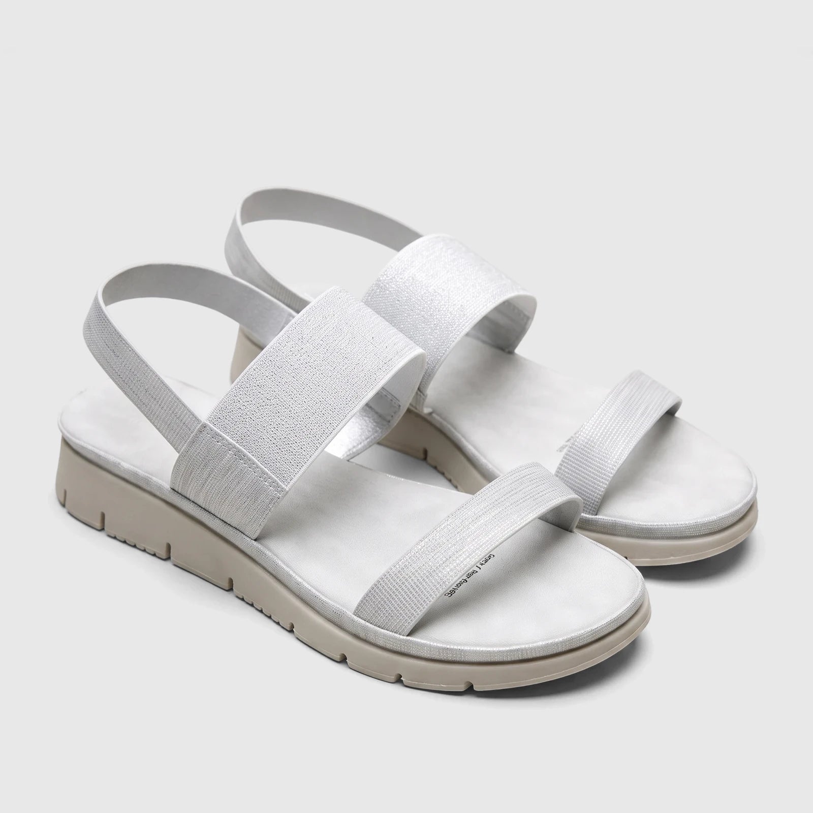 Pair of silver Hush Puppies Telina comfort sandals with textured straps and a light beige sole, angled view on a white