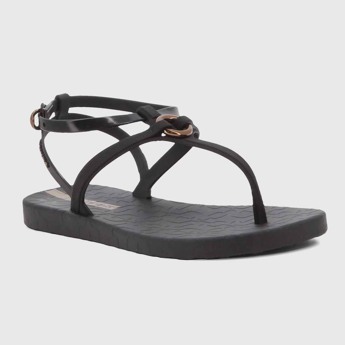 Black Ipanema Atena flat thong sandals for women, with an ankle strap and elegant beige hardware details.