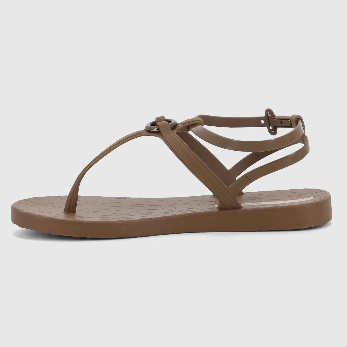 Brown Ipanema Atena thong sandal with an adjustable ankle strap and circular ring detail, shown in a side view.