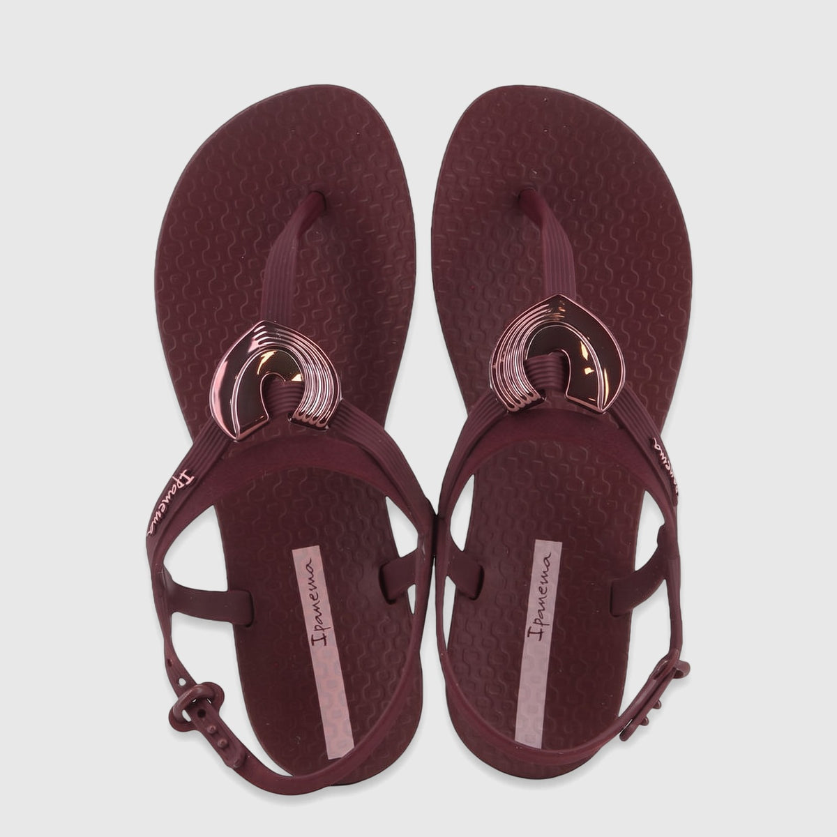A pair of burgundy Ipanema Class Dreamy sandals with metallic heart embellishments and adjustable ankle straps, viewed from