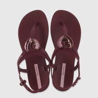 A pair of burgundy Ipanema Class Dreamy sandals with metallic heart embellishments and adjustable ankle straps, viewed from