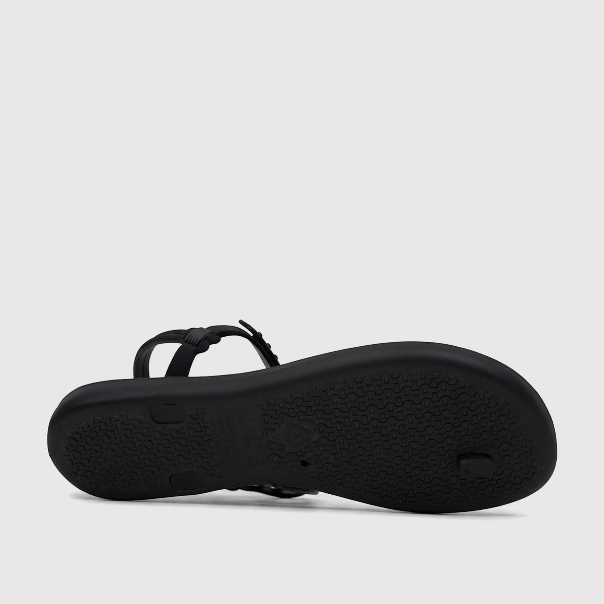 Black Ipanema Class Lizz Sandal shown from the bottom, featuring a textured sole with embossed branding and visible straps.