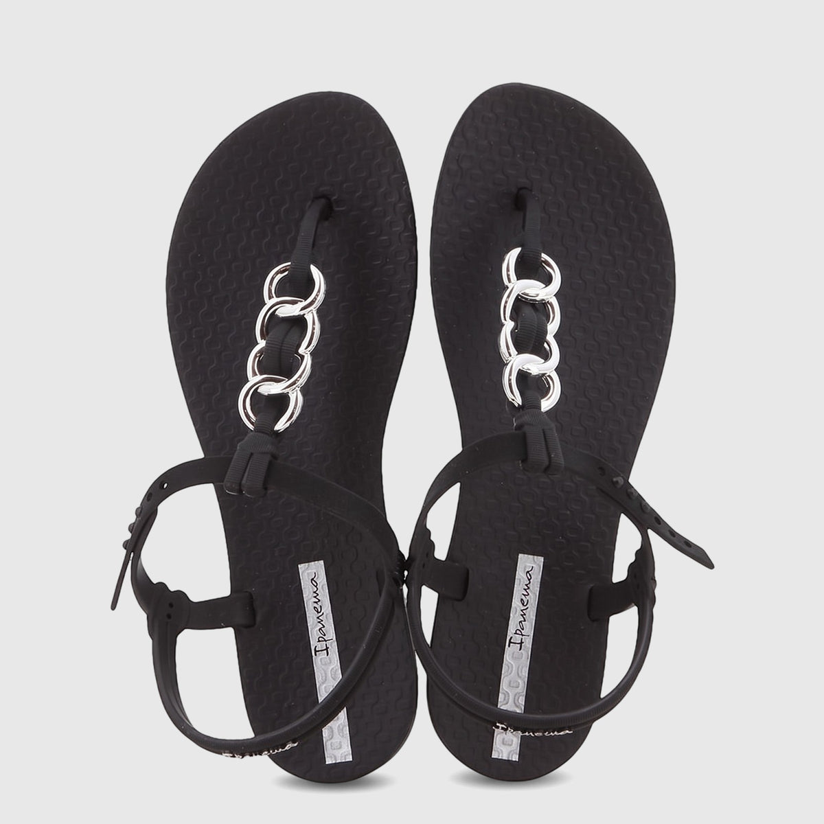 A pair of stylish black Ipanema Class Lizz sandals with elegant silver chain detailing on the thong straps, presented