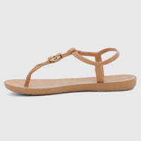 Side view of a single Ipanema Class Luma GIL27428 sandal in beige brown, featuring a braided T-strap and gold heart detail.