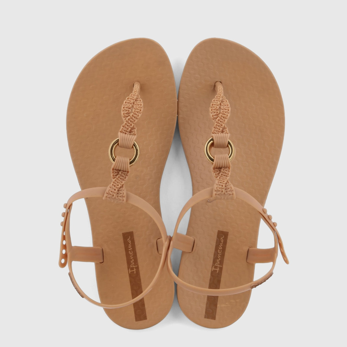 Pair of Ipanema Class Luma women's sandals in beige-brown, featuring braided T-straps with gold rings and adjustable ankle