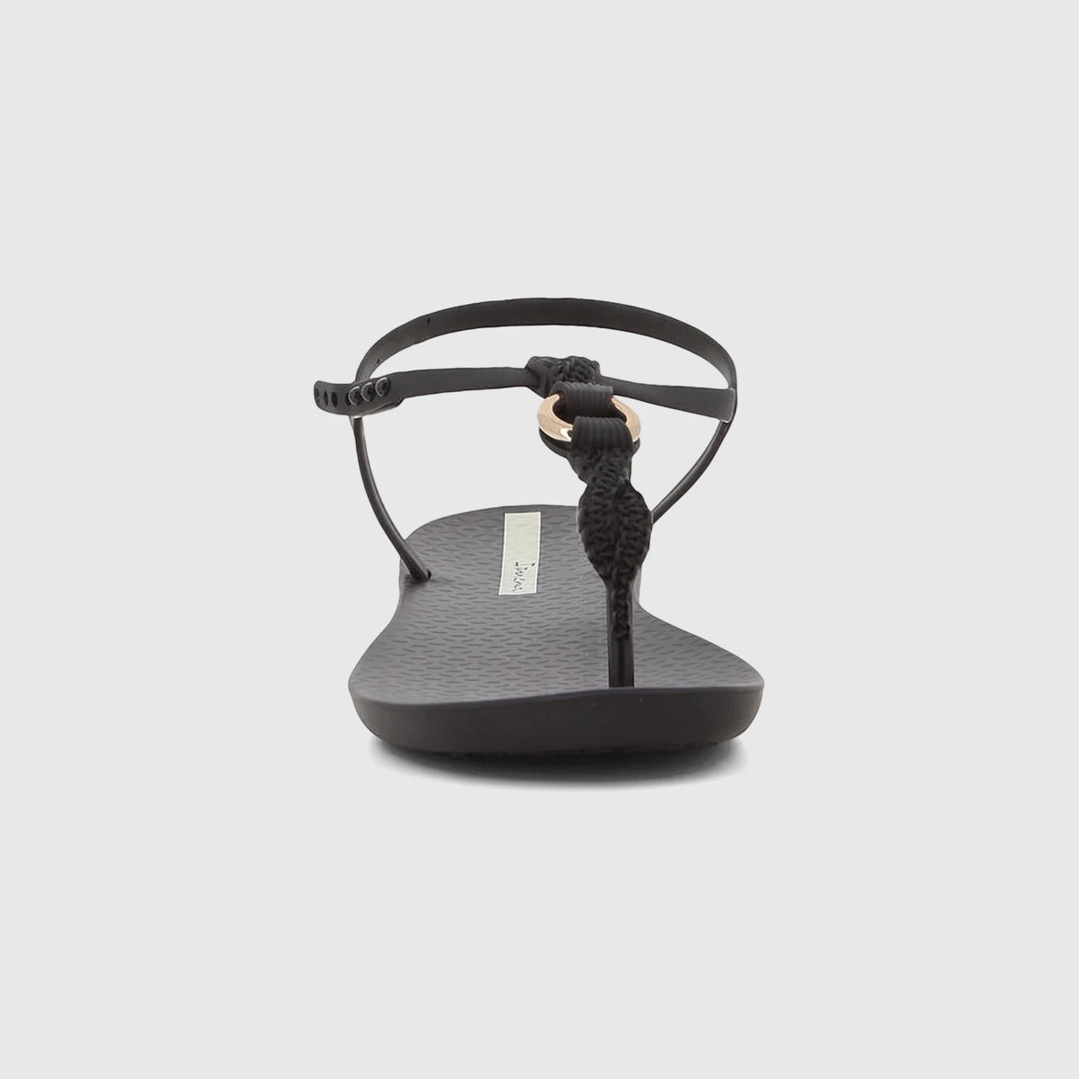 Front view of an Ipanema Class Luma women's sandal in black with a braided thong strap and gold ring detail.