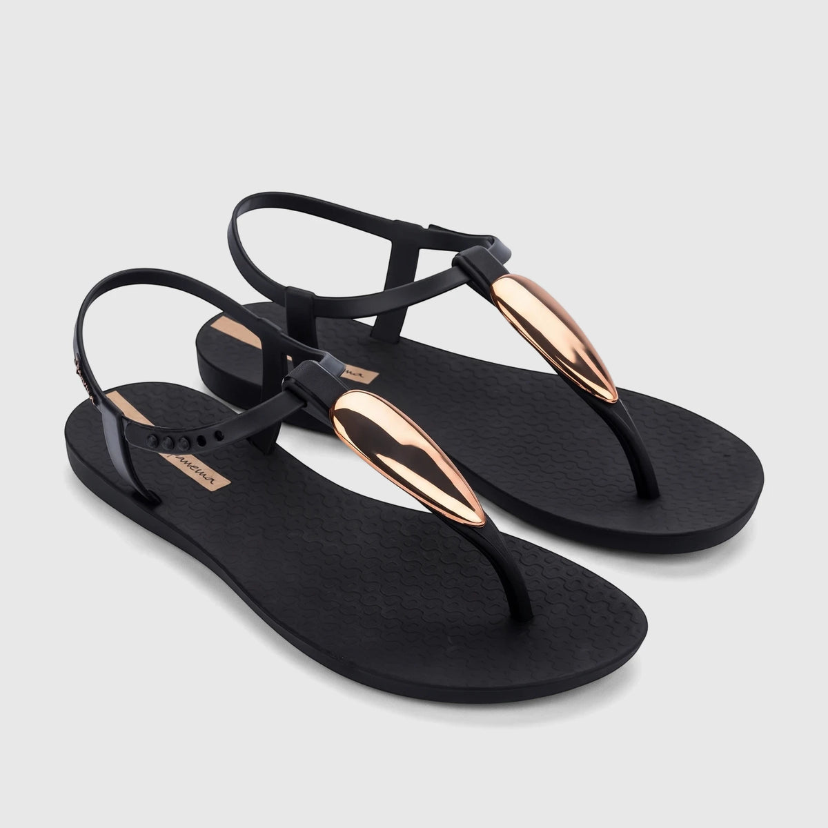 Pair of black Ipanema Class Luxury T-strap sandals with metallic gold teardrop embellishments and adjustable ankle straps.