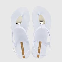 White Ipanema Class Luxury sandals with gold-tone oval hardware and ankle straps, shown from a top-down view.