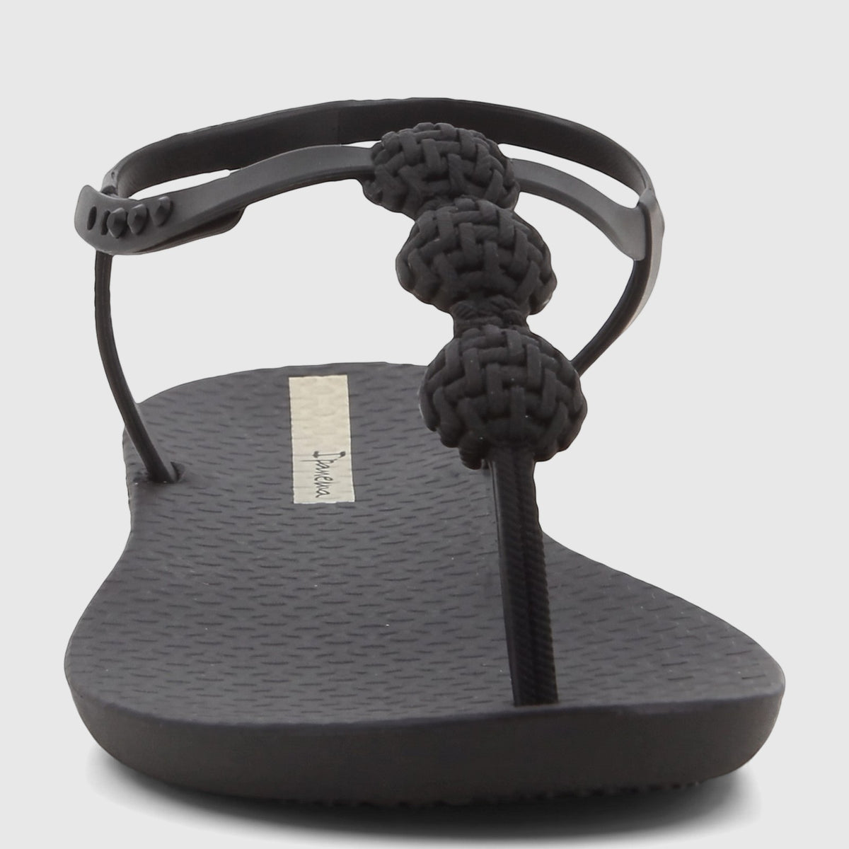 Black Ipanema Class Posh Sandal with braided thong strap, low angle front view, featuring a textured sole.