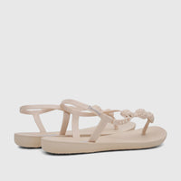 Pair of beige Ipanema Class Posh thong sandals with braided straps and blue logo, photographed from a low angle.