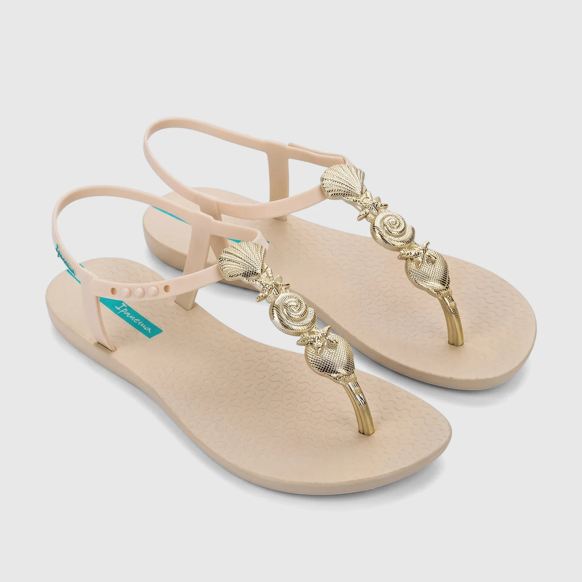 Ipanema Fundo Do Mar women's flat sandals in beige with gold seashell and spiral embellishments, viewed from above.