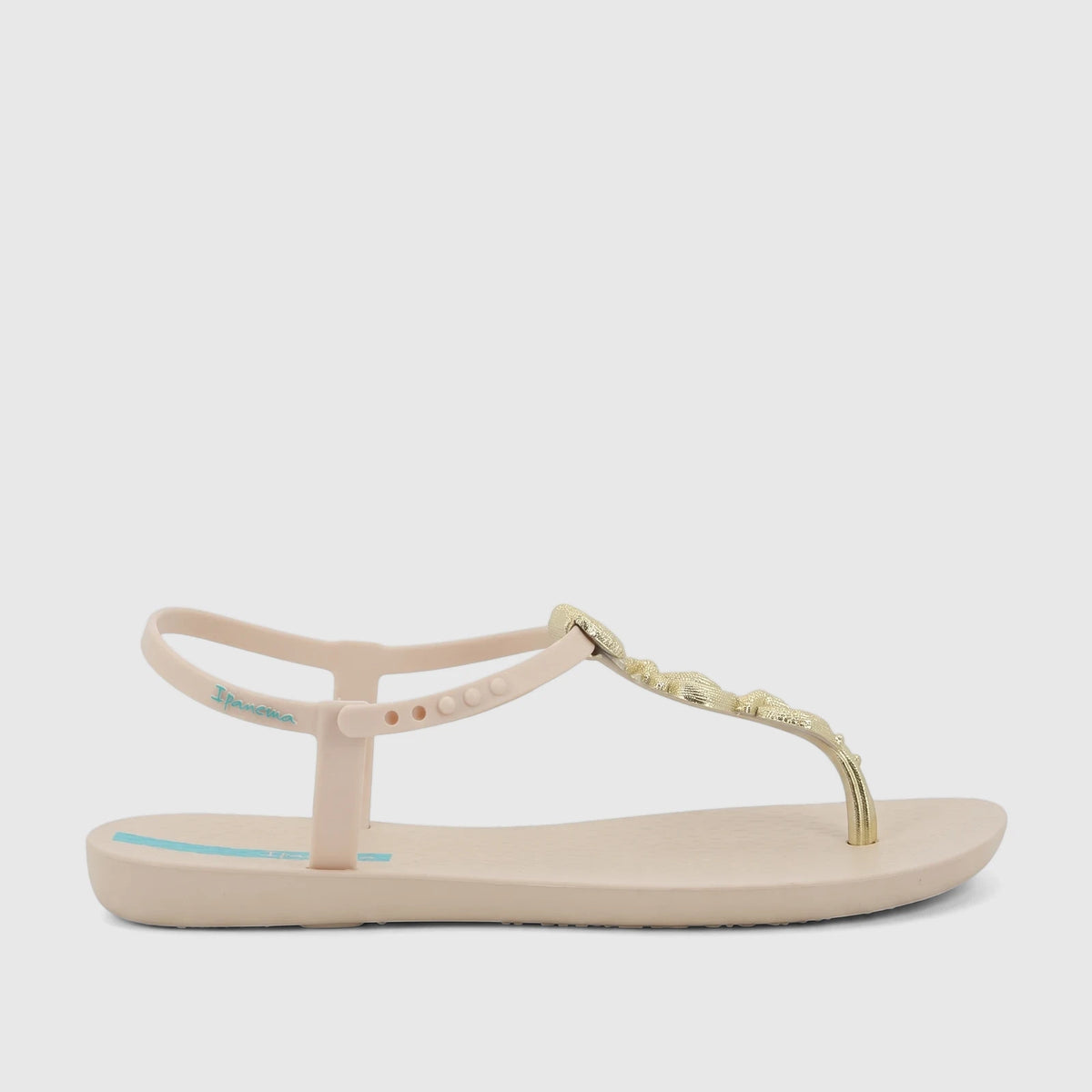 Ipanema Fundo Do Mar women's thong sandal in beige with a gold seashell-inspired strap, presented in a side view.