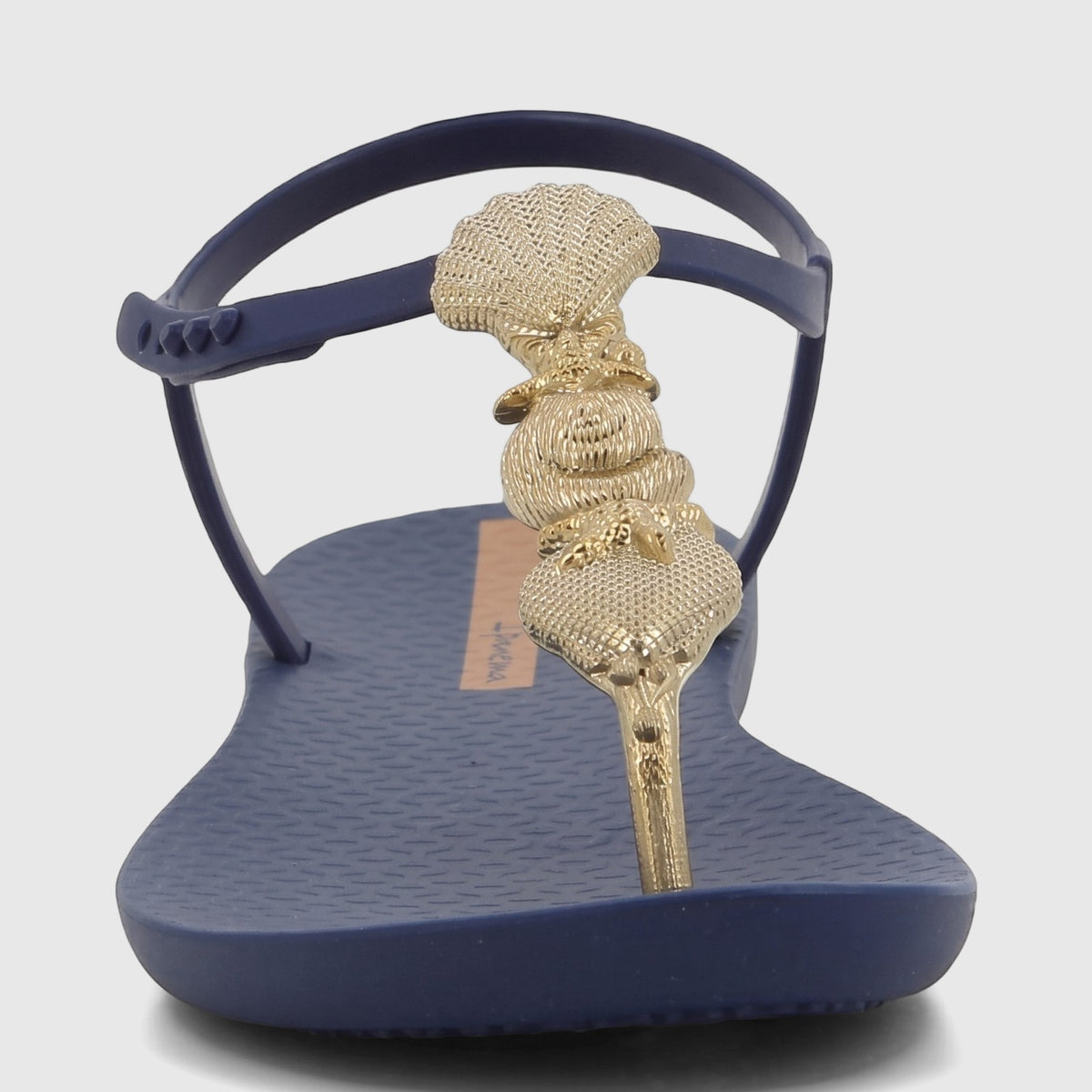Ipanema Fundo Do Mar navy blue thong sandals with a textured gold seashell-inspired T-strap, presented from a front view on