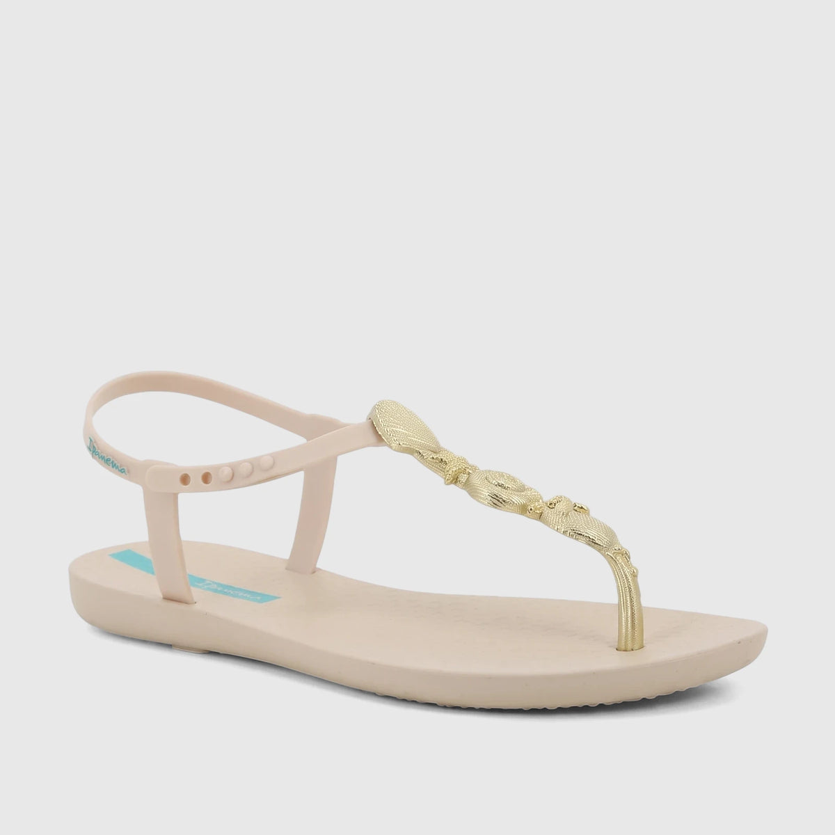 Ipanema Fundo Do Mar women's thong sandals in beige with an ornate gold T-strap and an adjustable ankle strap.