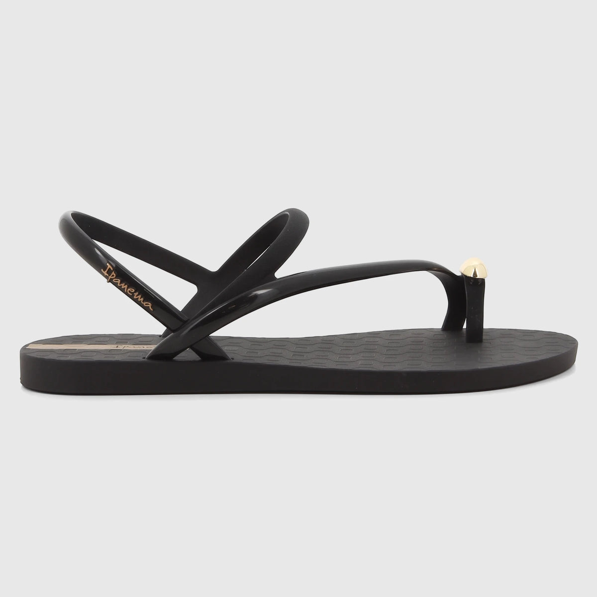 Black Ipanema Glam Ring Sandal with a gold ring detail on the toe post, showcasing its sleek design from a side profile.