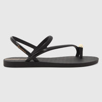 Black Ipanema Glam Ring Sandal with a gold ring detail on the toe post, showcasing its sleek design from a side profile.